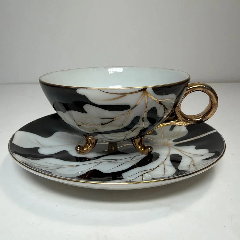 Footed Tea Cup and Saucer Black White Gold Leaf MCM Holywood Regency Art Deco